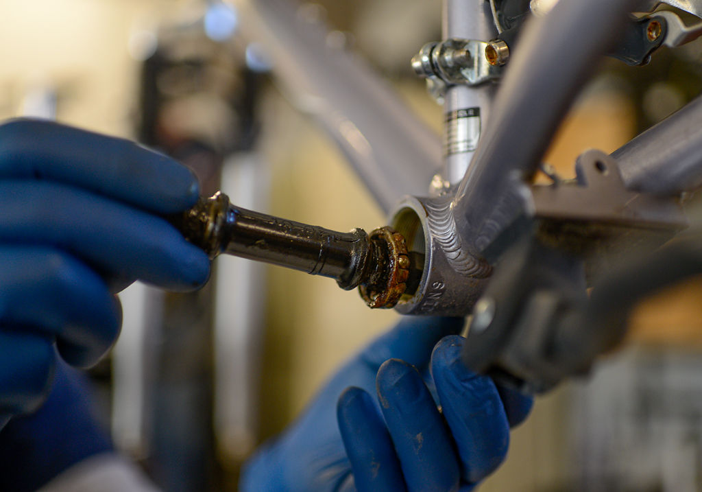 Sid Popejoy removes a bicycle part for cleaning